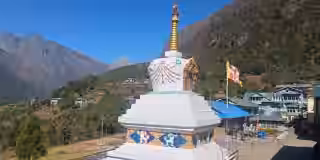 Namche's monastery stupa with forested hill