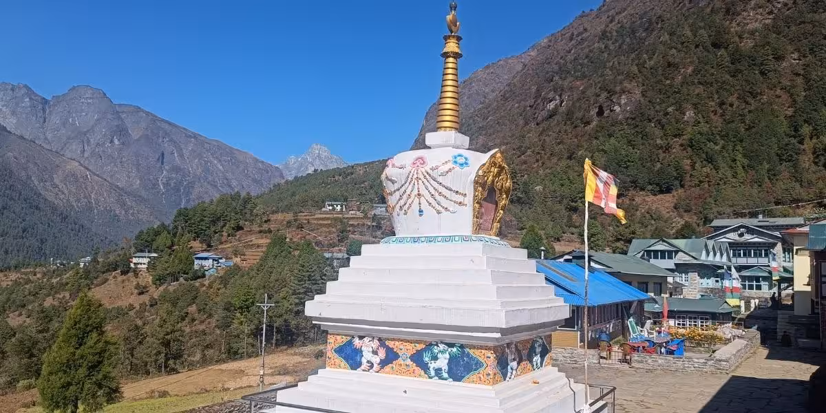 Namche's monastery stupa with forested hill