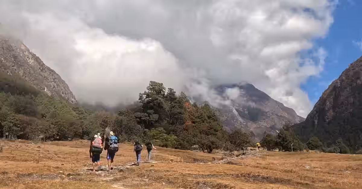 Mountain hiker carrying backpack in Kanchenjunga with guide