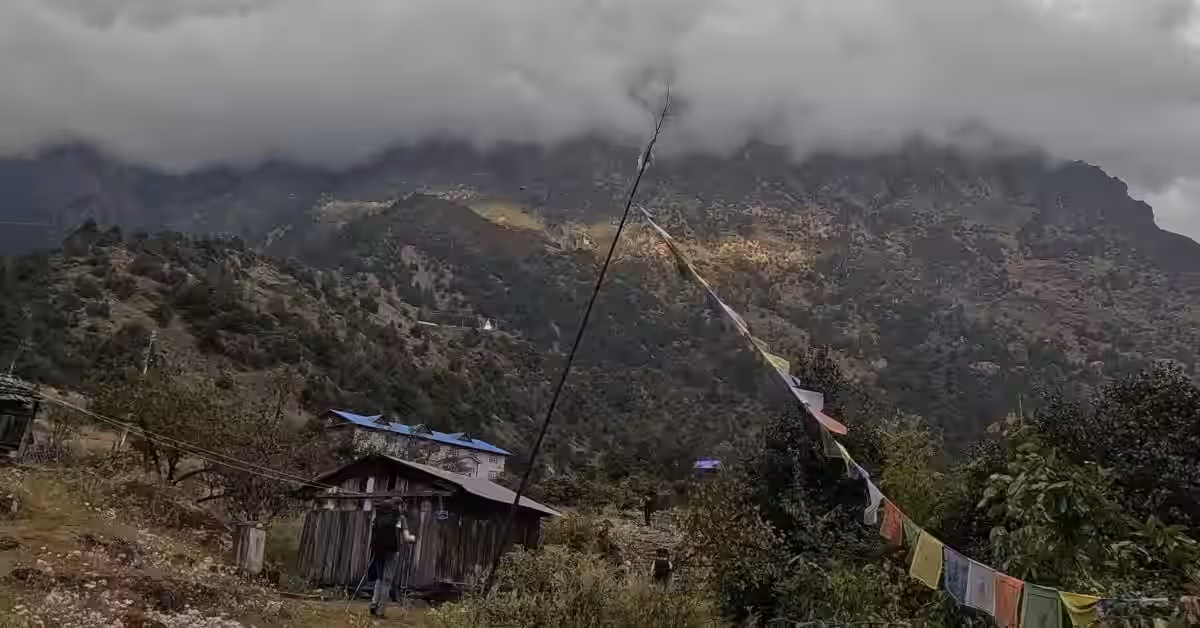 Trekker walking toward fog-covered hills in Kanchenjunga