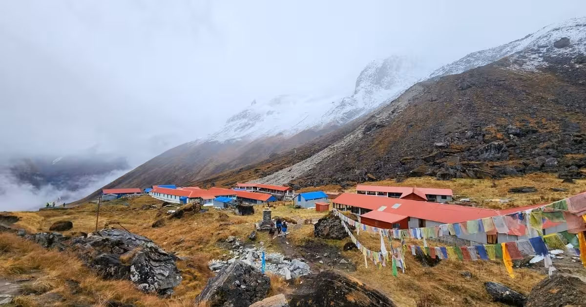 Annapurna Base Camp lodges surrounded by snowy peaks and prayer flags