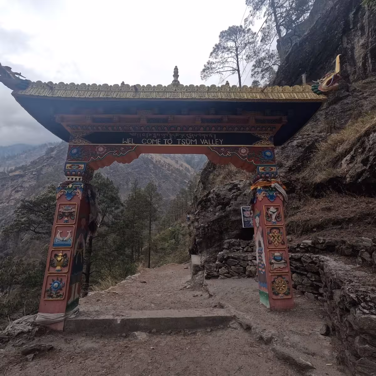 Colorful traditional gate welcoming trekkers into Tsum Valley