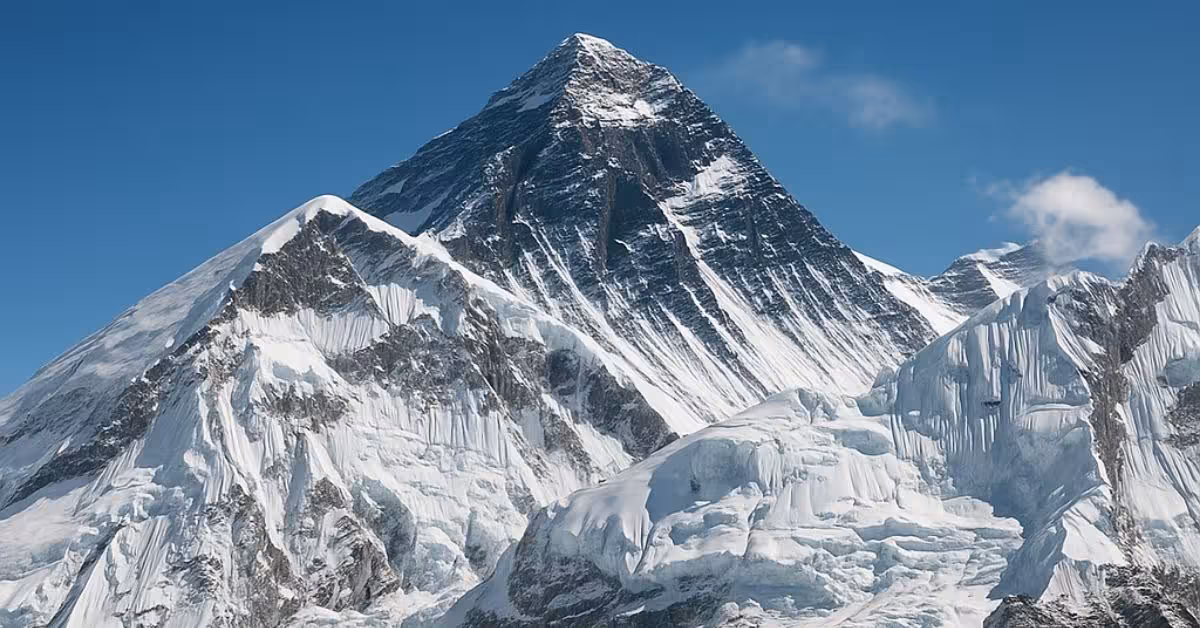 Snow-covered Mount Everest under clear blue sky