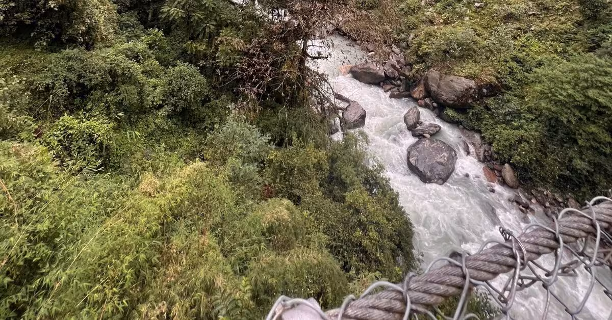 Chhomrong trail with forested valley and river below