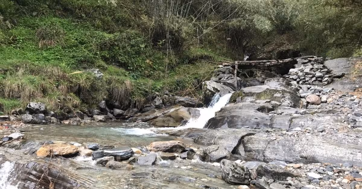 Small wooden bridge over a rocky stream on the Annapurna Base Camp trail in autumn