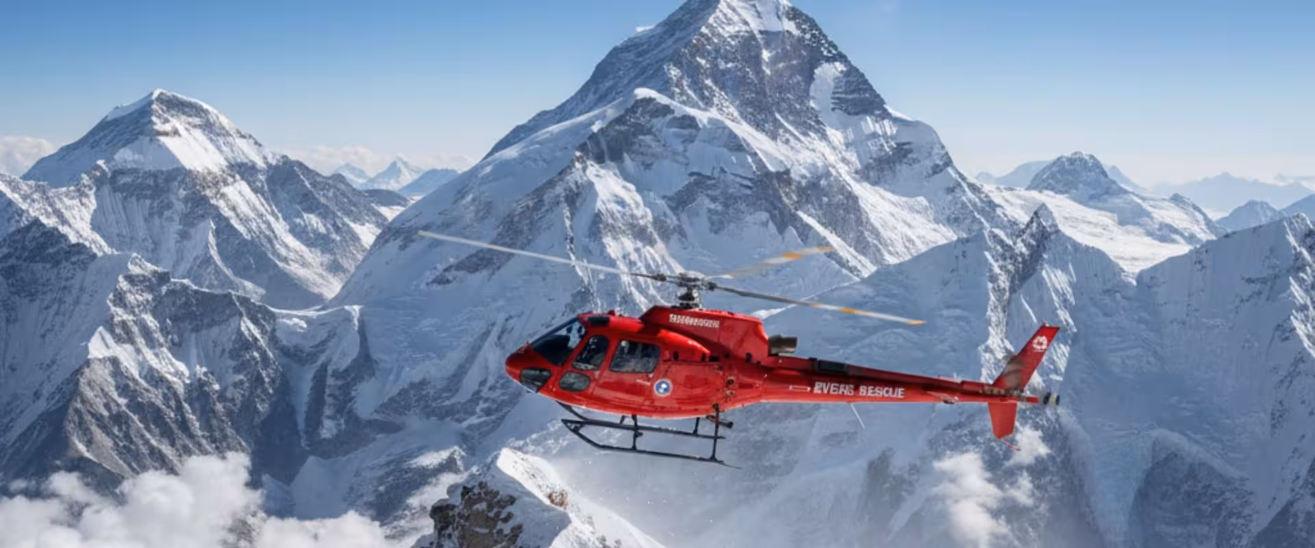 Rescue helicopter hovering to Everest peak