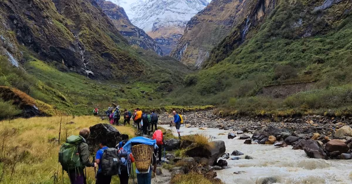 Trekkers ascend through a high-altitude valley toward Annapurna Base Camp