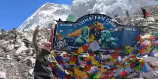 Happy-trekker-at-Everest-Base-Camp-signboard.jpg