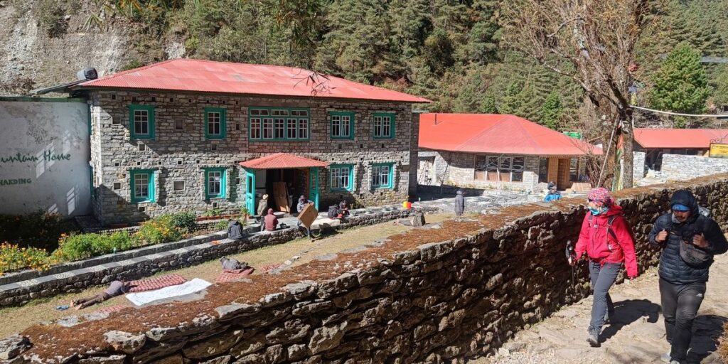 Mountain lodge with resting trekkers