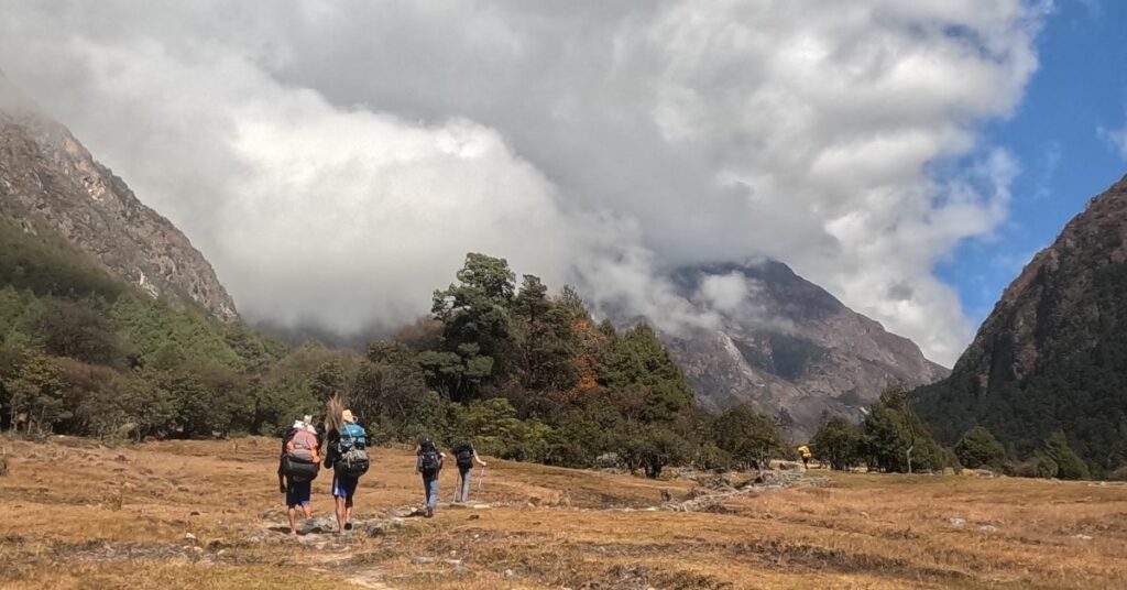 Mountain hiker carrying backpack in Kanchenjunga with guide