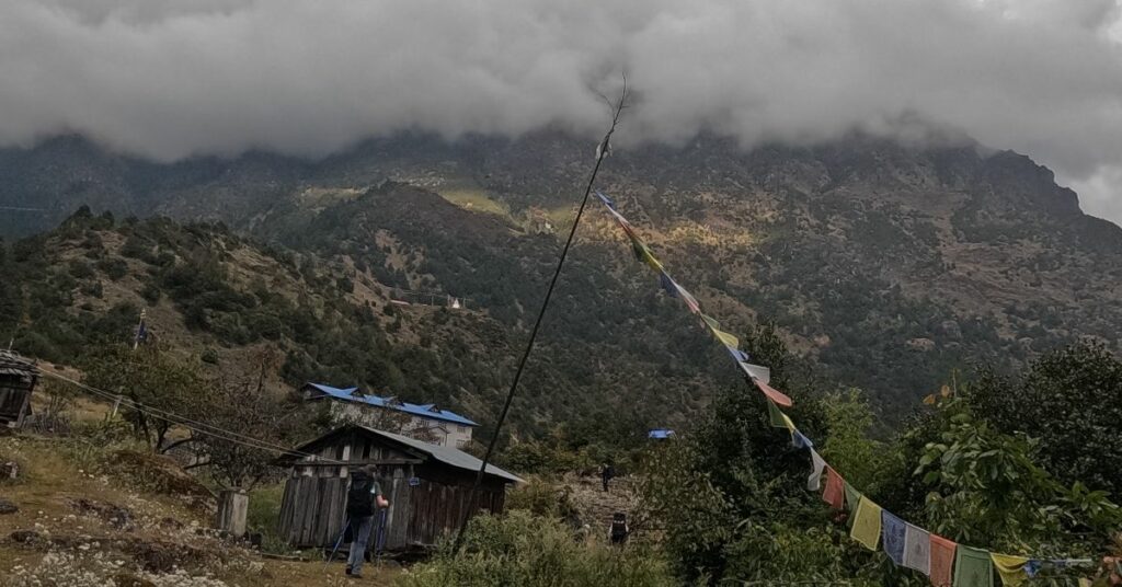 Trekker walking toward fog-covered hills in Kanchenjunga